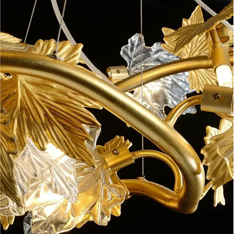 DecorBites crystal chandelier with golden and silver leaf-shaped metalwork and clear glass accents for modern rustic decor
