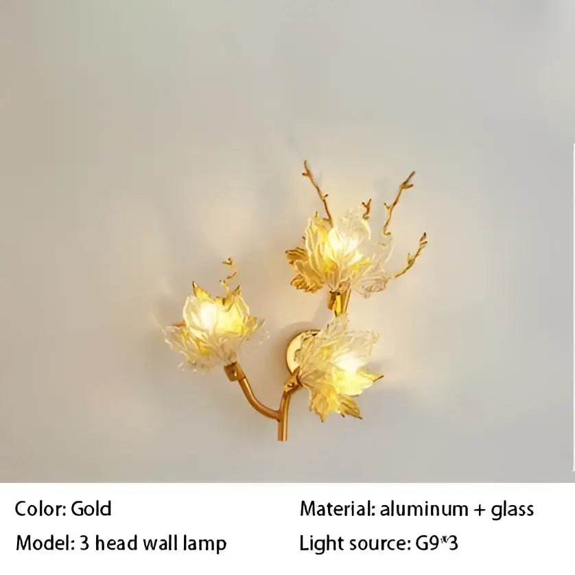 Gold-colored decorbites crystal chandelier wall lamp with three aluminum arms and delicate glass flower designs