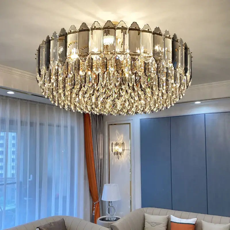 Decorbites crystal chandelier with gold-toned brass and cascading teardrop crystals for luxury living room lighting