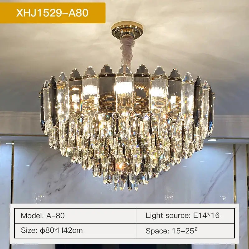 Luxurious gold-toned decorbites crystal chandelier with cascading clear and dark prisms and central brass fixture for living room light