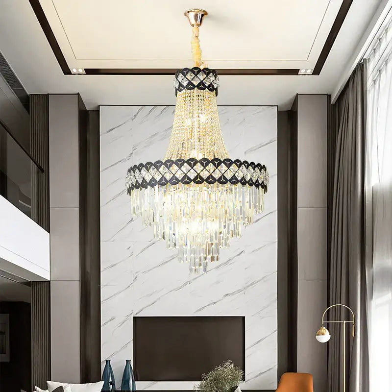 A luxurious gold-toned decorbites crystal chandelier with cascading crystals and a black diamond band for spiral staircase