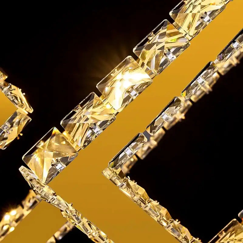 A dazzling gold-toned decorbites crystal chandelier with faceted rectangular beads for modern stair pendant lighting