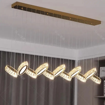 Gold-toned decorbites crystal chandelier stair pendant with five crystal-encrusted circular lights in wavy pattern