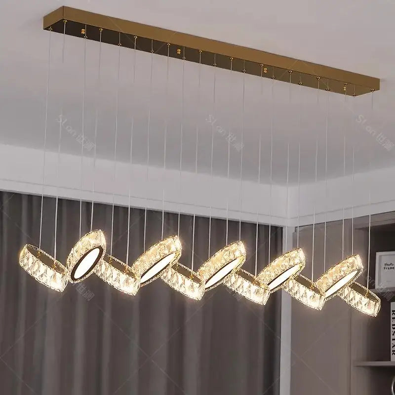 Gold-toned decorbites crystal chandelier stair pendant with five crystal-encrusted circular lights in wavy pattern
