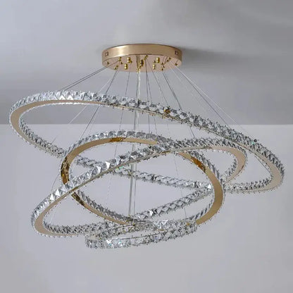 A modern decorbites crystal chandelier with gold-toned rings and clear crystals for living room lighting