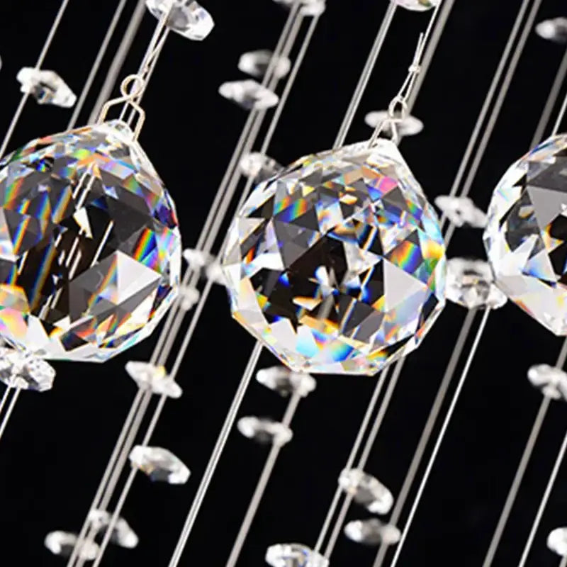 Faceted crystal chandelier droplets on thin wires creating a rainbow effect in decorbites crystal chandelier stair pendant lamp