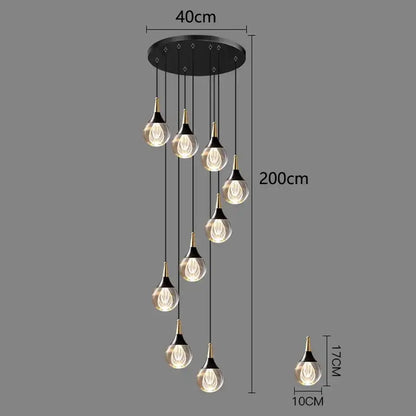 Modern black crystal chandelier stair pendant with seven gold-topped teardrop glass bulbs emitting warm light