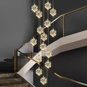 A decorbites crystal chandelier pendant lamp with gold-toned chains and faceted crystal globes for stair lighting