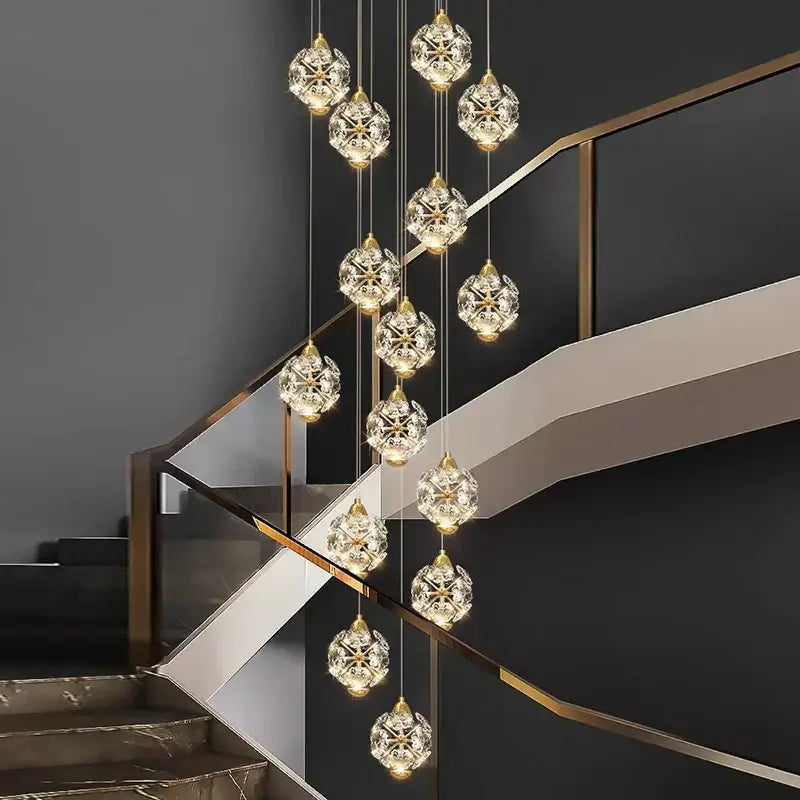 A decorbites crystal chandelier pendant lamp with gold-toned chains and faceted crystal globes for stair lighting