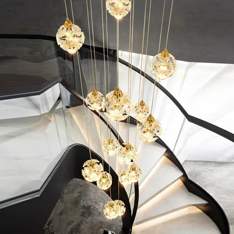A modern DecorBites crystal chandelier stair pendant lamp with spherical crystal pendants and warm glowing lights