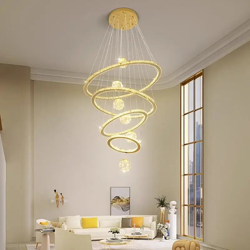 Golden spiral DecorBites crystal chandelier pendant lamp with crystal accents and spherical lights for stair lighting