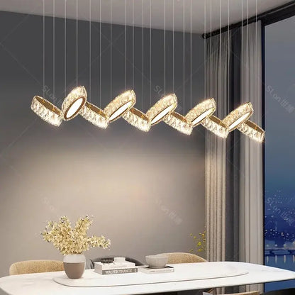 Gold-toned crystal-encrusted DecorBites crystal chandelier stair pendant with a modern zigzag design for living room lighting