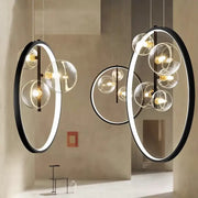 Modern black-framed pendant light with glowing rings and glass bulb clusters in decorbites crystal chandelier stair design