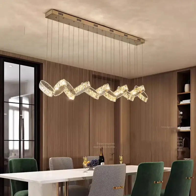 A decorbites crystal chandelier stair pendant with a sleek metallic frame and cascading crystal rings emitting warm light