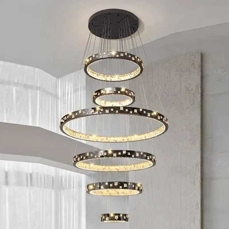 Modern black and gold DecorBites crystal chandelier stair pendant with tiered design and crystal accents for living room lighting