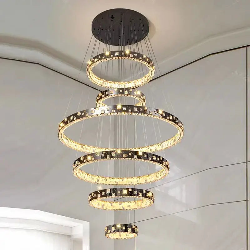 A modern decorbites crystal chandelier stair pendant lamp with cascading clear crystals and black metal accents