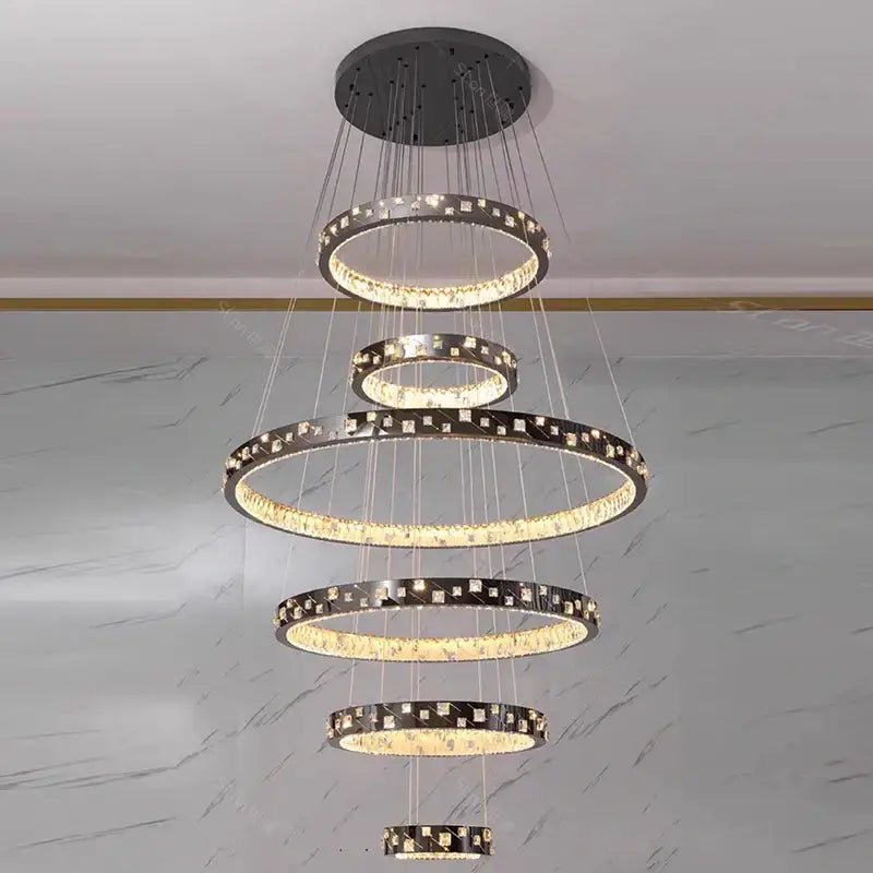 Decorbites crystal chandelier stair pendant lamp with five tiered rings and crystal accents illuminated by warm led lights