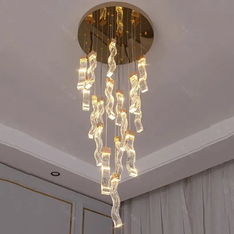 A modern gold-toned decorbites crystal chandelier pendant lamp with cascading glass elements for living room lighting