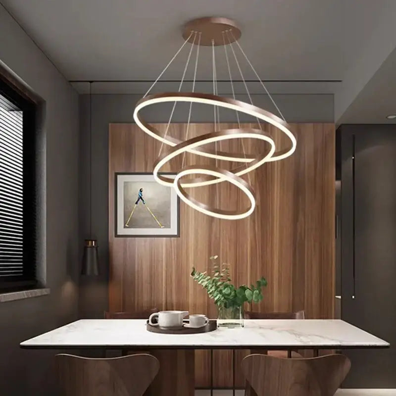 Modern copper-toned decorbites crystal chandelier pendant lamp with three interlocking rings for stair lighting