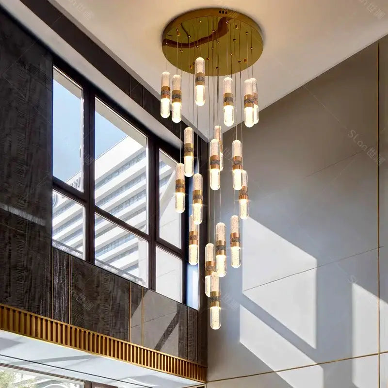 A decorbites crystal chandelier stair pendant lamp with gold ceiling mount and cylindrical glass pendant lights