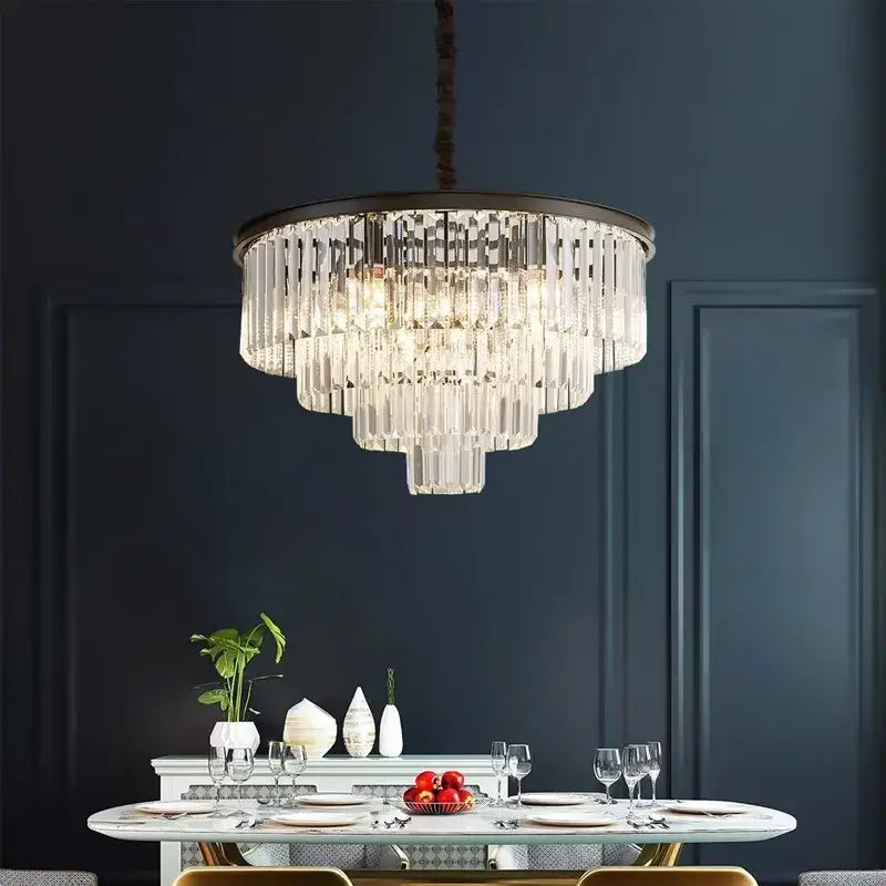 A multi-tiered decorbites crystal chandelier stair pendant light with a dark metal frame hanging above a dining table