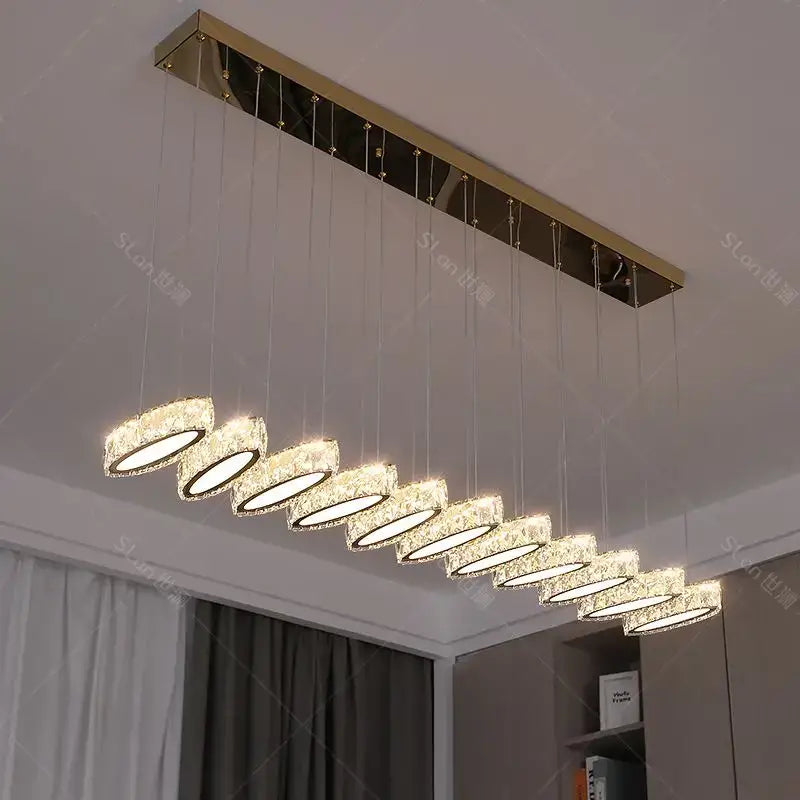 Modern rectangular decorbites crystal chandelier with gold-toned metal frame and crystal encased led bulbs for living room lighting