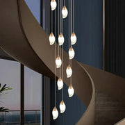 Modern pendant chandelier with teardrop glass shades and brushed gold accents for living room by decorbites crystal chandelier