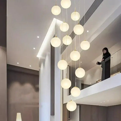 Modern spherical pendant light with frosted glass globes and gold metal accents from DecorBites crystal chandelier stair series