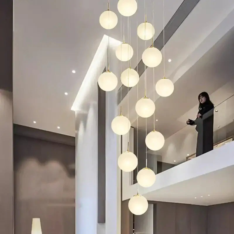 Modern spherical pendant light with frosted glass globes and gold metal accents from DecorBites crystal chandelier stair series