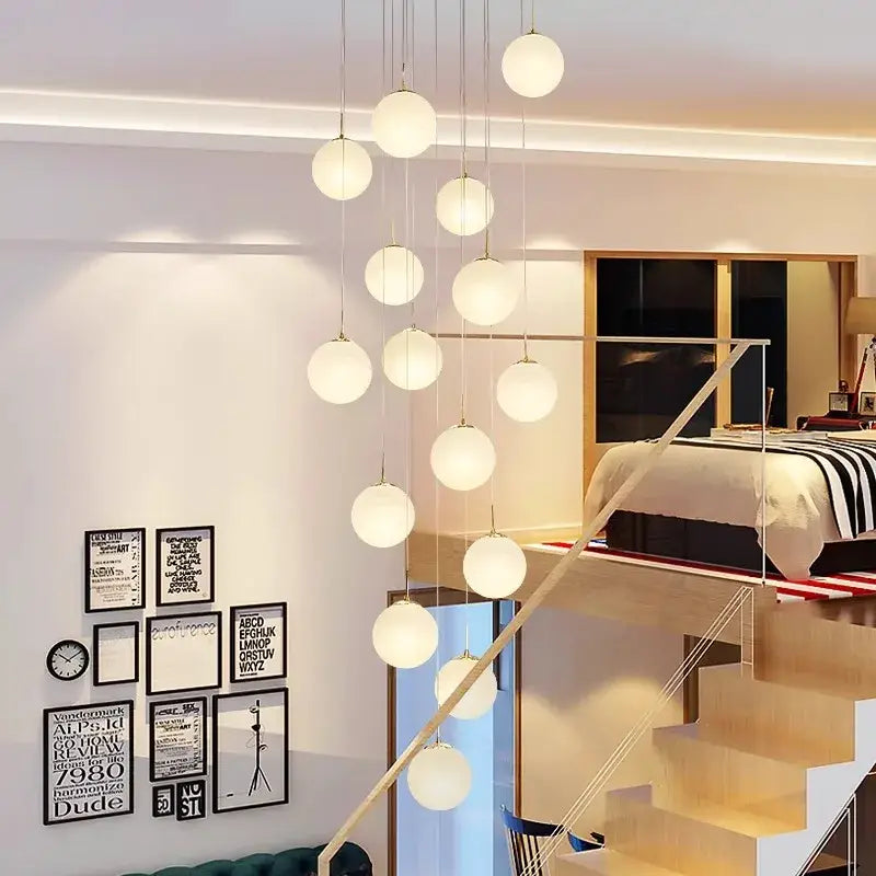 Modern spherical pendant light with frosted glass orbs and metallic chains in decorbites crystal chandelier stair design