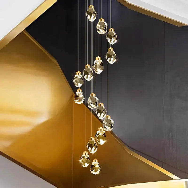 A modern gold-toned crystal chandelier pendant light with faceted geometric design by DecorBites for living rooms