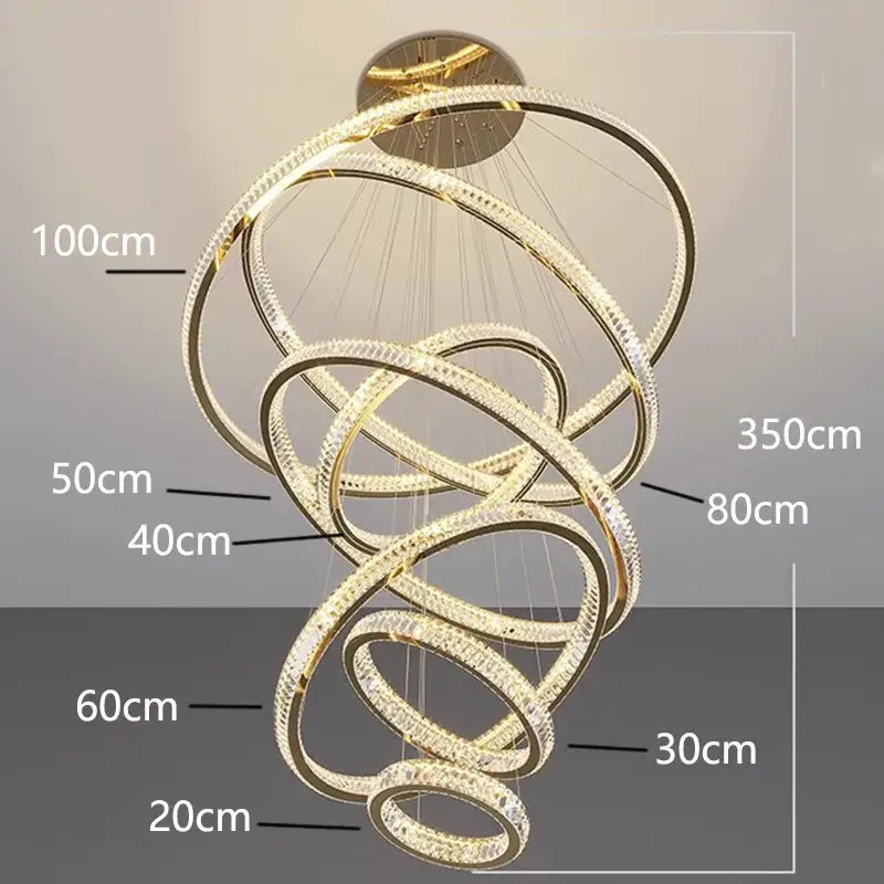 Golden spiral DecorBites crystal chandelier with interlocking rings and clear crystals for stair pendant lighting