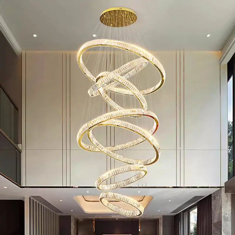 Golden spiral decorbites crystal chandelier with crystal-encrusted rings and circular ceiling mount for stair pendant lighting