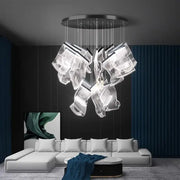Modern decorbites crystal chandelier pendant light with translucent sculptural glass elements and metallic circular base