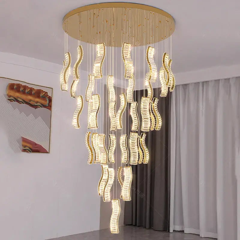 Gold-toned DecorBites crystal chandelier with cascading wave-shaped crystals pendant light for modern stair lighting