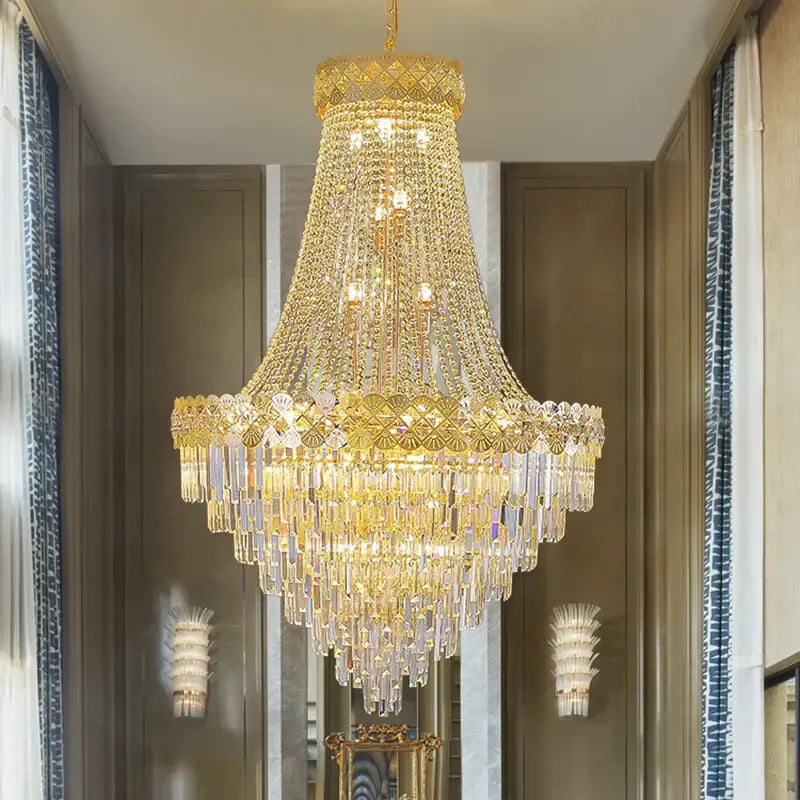 Luxurious gold-toned decorbites crystal chandelier with cascading clear faceted crystals for villa and hotel lobby use