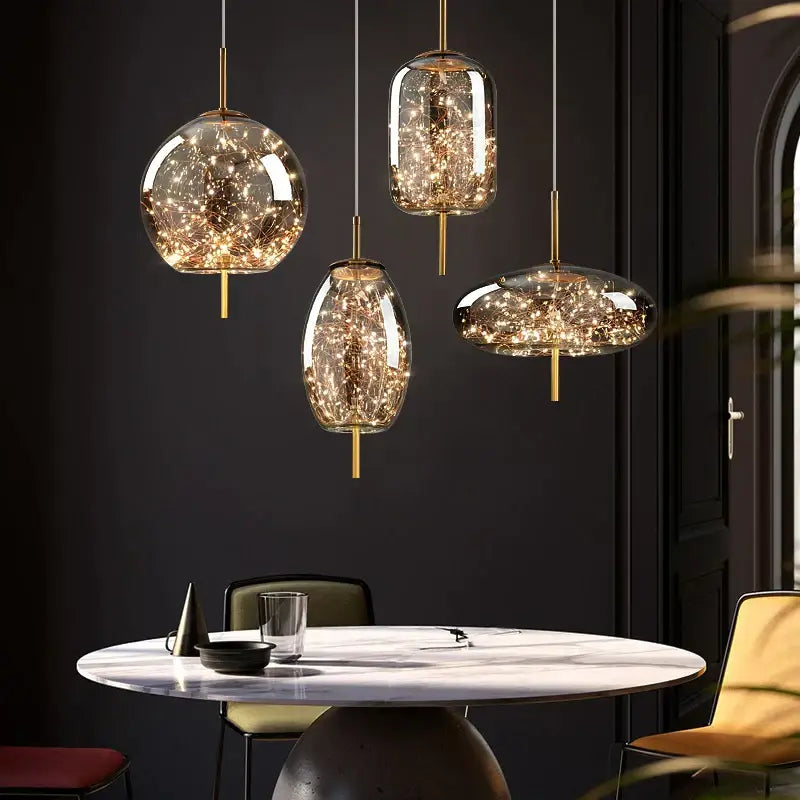 Four elegant glass decorbites crystal chandelier pendant lights with golden fixtures and warm led fairy lights inside