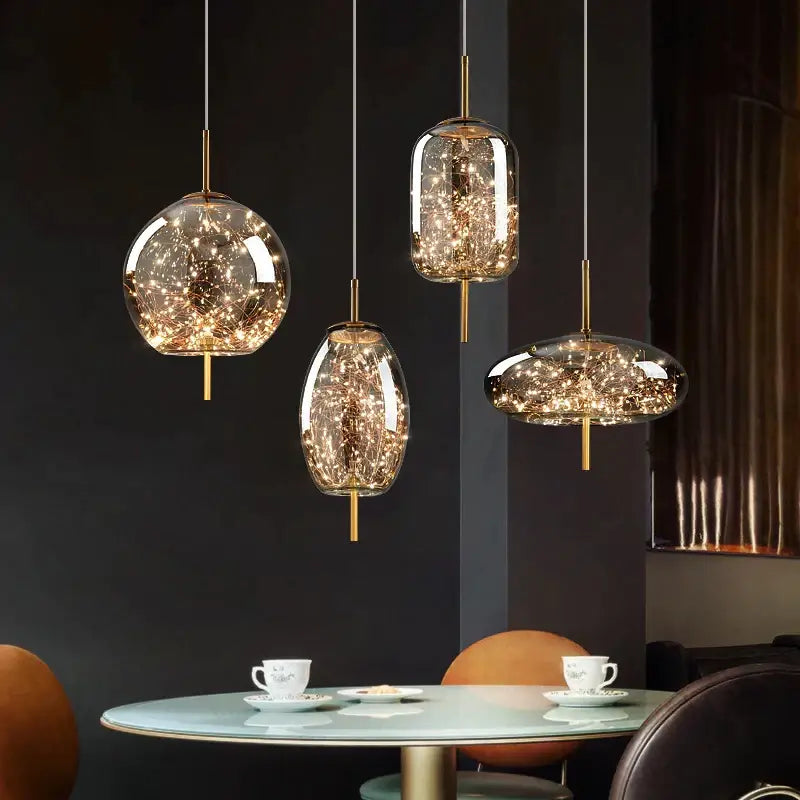 Three modern pendant lights with clear glass globes and warm LED fairy lights in gold fixtures from decorbites crystal chandelier for kitchen decor