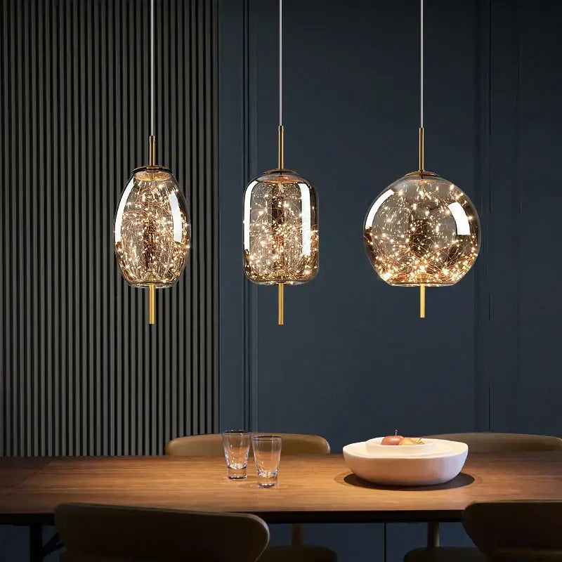 Three elegant glass pendant lights with golden fixtures and warm led lights in decorbites crystal chandelier design