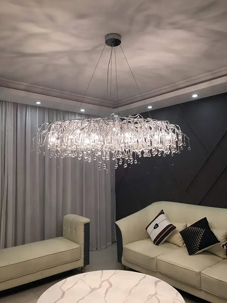 DecorBites™ crystal chandelier with silver metal frame and raindrop crystals as an elegant light fixture