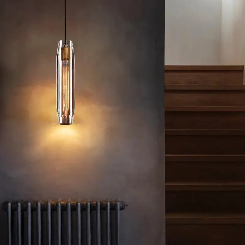 A modern decorbites crystal copper chandelier with clear glass cylinder and exposed filament bulb for living room lighting