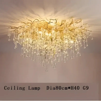 Gold-toned decorbites crystal drop chandelier with cascading crystal droplets and intricate golden branching arms for dining room