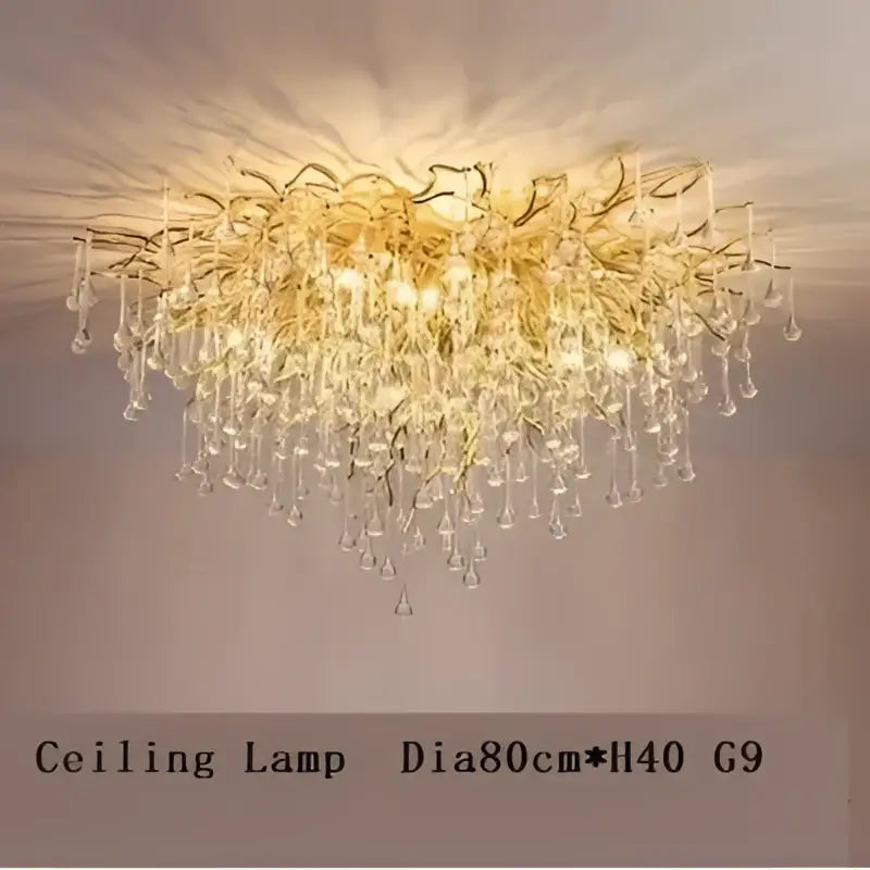 Gold-toned decorbites crystal drop chandelier with cascading crystal droplets and intricate golden branching arms for dining room