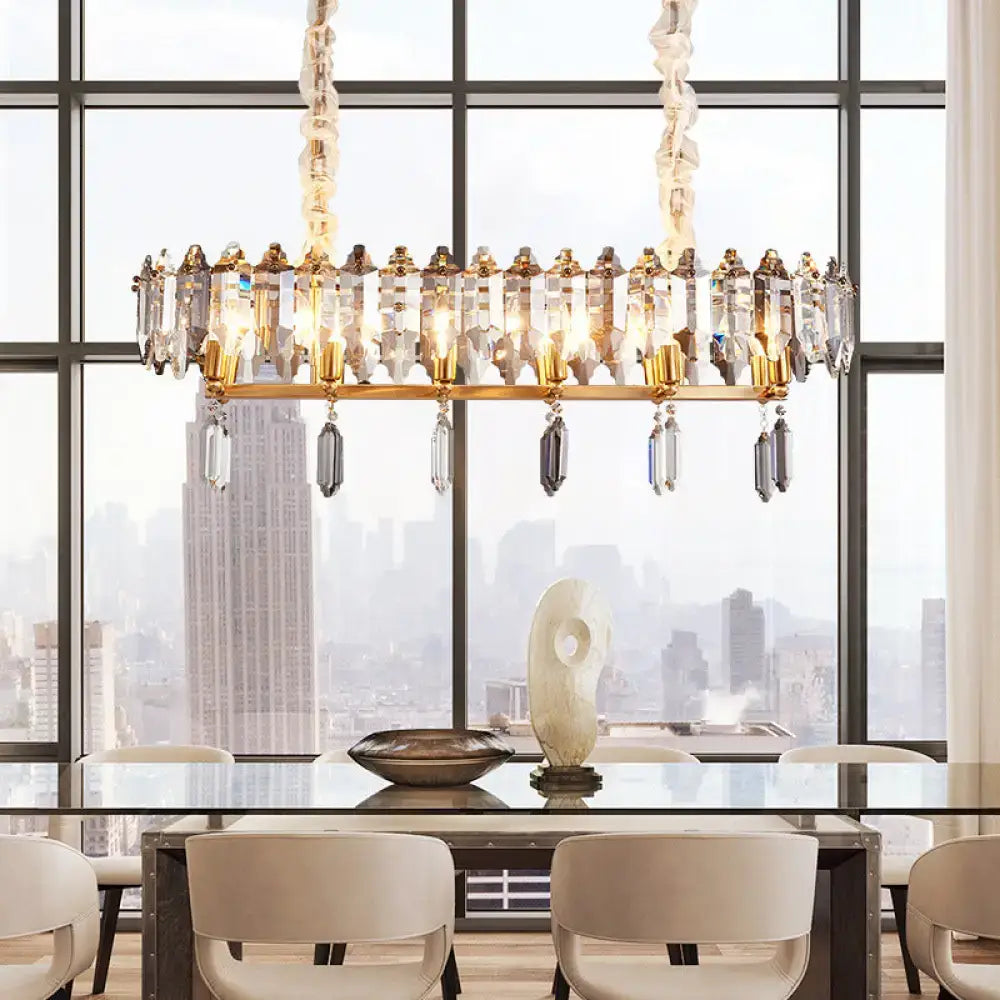Gold-toned DecorBites™ crystal drop island lighting with modern clear oval design and smoky crystal accents for dining hall