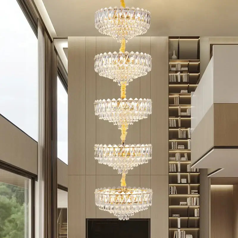 A decorbites crystal duplex chandelier with a golden frame and clear glass prisms for living room lighting