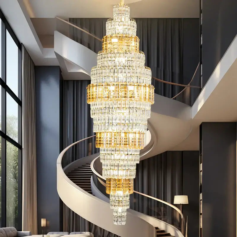 Decorbites crystal duplex multi-tiered chandelier with gold accents hanging above spiral staircase for luxe living room lighting