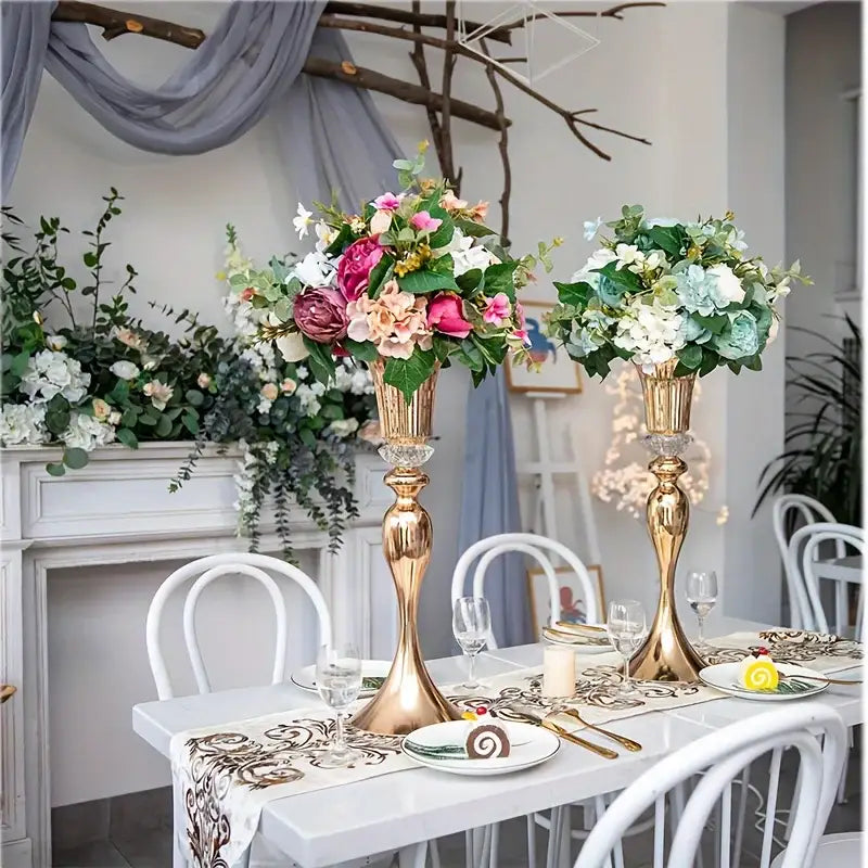 Decorbites crystal flower stand set features two 22 inch tall gold metal vases with fluted designs and floral arrangements