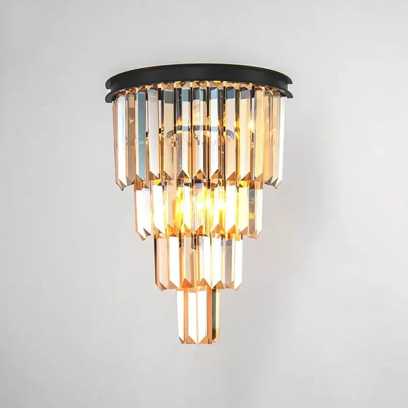 A tiered decorbites crystal gold chandelier with a black base and amber glass prisms for living room lighting