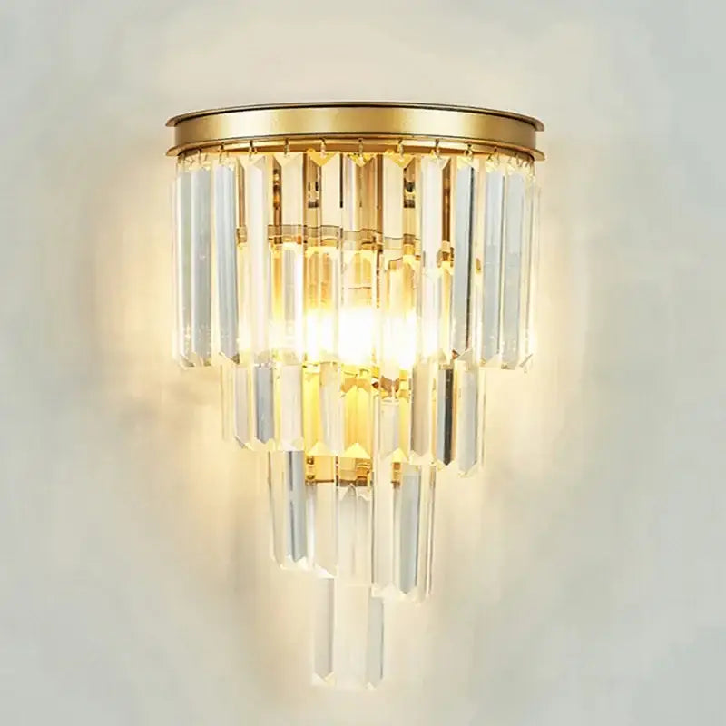 Gold-toned wall sconce with cascading clear crystal prisms in decorbites crystal gold chandelier for living room light