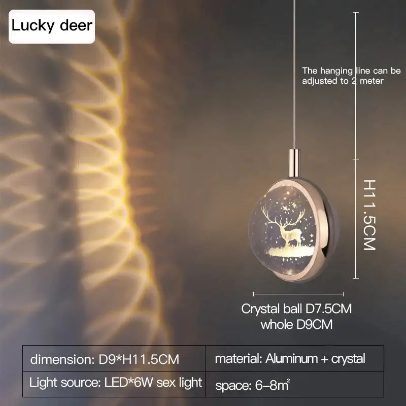 A sleek gold crystal jellyfish chandelier pendant light by decorbites featuring a circular crystal ball and deer silhouette